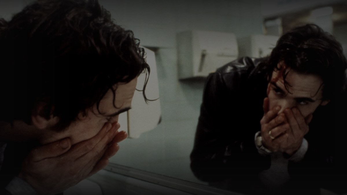 Still from Drugstore Cowboy (1989) — 16:9 still from Letterboxd (the 1200x675 crop variant), baked through scripts/bake_dark_photo.py at default factor 0.45, output mean brightness 33.4 (in the 25-35 daylight range). source: a.ltrbxd.com/resized/sm/upload/5w/6h/79/ib/drugstore-1200-1200-675-675-crop-000000.jpg
