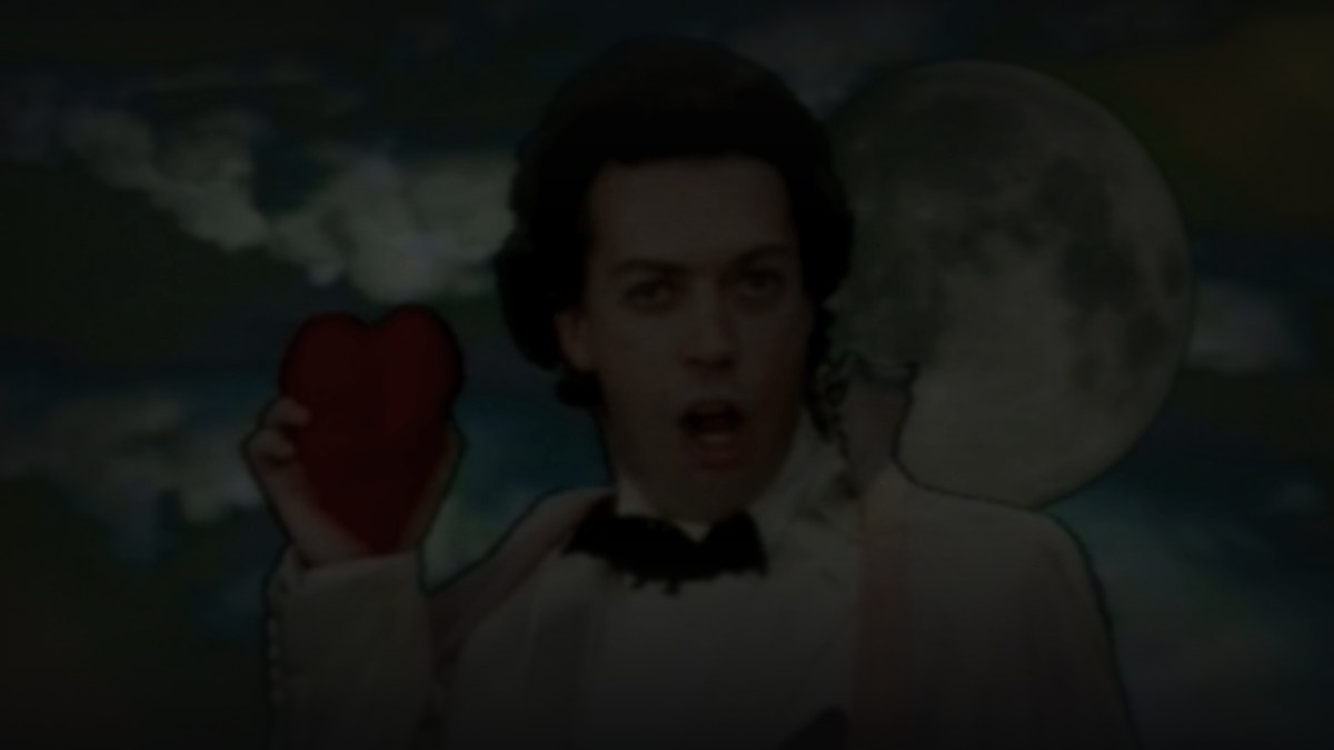 Still from The Worst Witch (1986) — 16:9 still from Letterboxd (the tmdb alternative-backdrop variant), source pre-darkened 0.55 to handle the very high-key lighting, then baked through scripts/bake_dark_photo.py at default factor 0.45, output brightness 21.4 within the night-scene / interior range